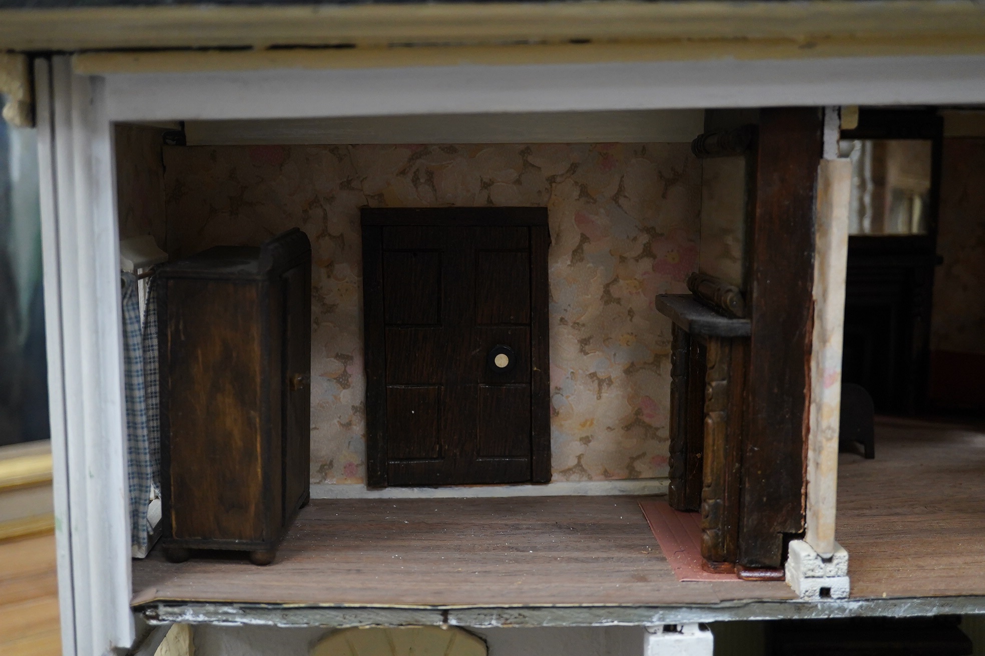 A mid-20th century green and white plywood doll's house, with a pyramid hip tiled roof, together with some plywood furniture including furniture from the Pit-A-Pat Series, height 67cm, width 54cm, depth 54cm. Condition -